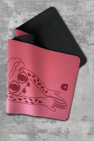 Yoga folded with black natural rubber base and laser printed design on a concrete surface.