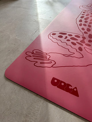 Yoga mat detail with laser printed design and URCA logo on a concrete surface.