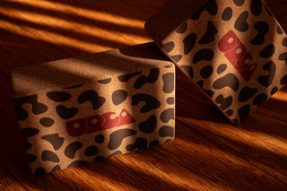 100% spanish cork yoga blocks with leopard print and URCA logo still life in a sunlit room with hard shadows nd sun rays on the product